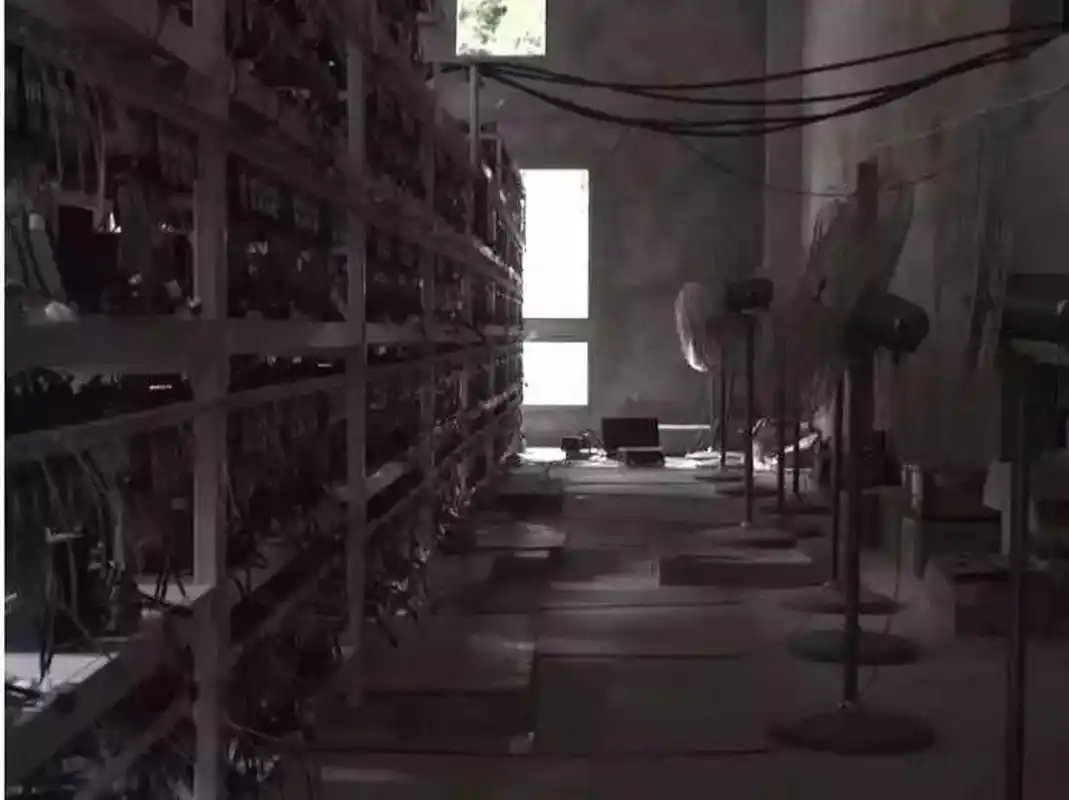 A miner checking on the status of a mining rig